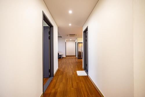 an open hallway with white walls and wooden floors at Jeju Arumdaun Resort in Seogwipo