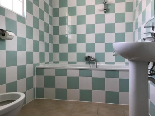 a bathroom with a sink and a tub and a toilet at Villa in Les Forges with Golf & Pool Access in Les Forges