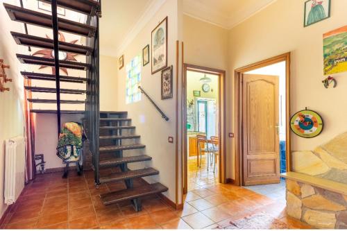 a hallway with a spiral staircase in a home at La Torre di Barbara in Ardea