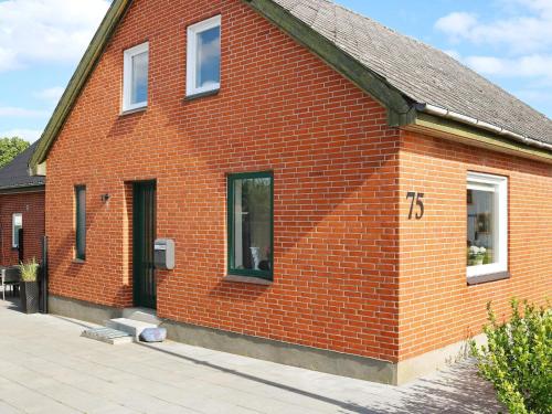 a red brick building with a sign on it at 10 person holiday home in Hadsund-By Traum in Hadsund