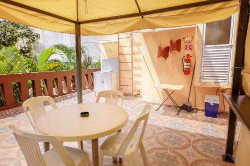 a table and chairs with an umbrella on a balcony at Casa Saab in Playa del Carmen