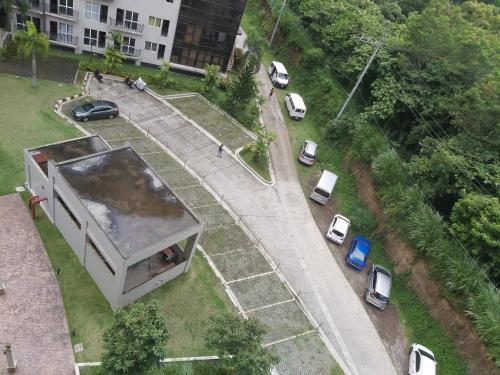 a small house on a street with parked cars at Affordable Tagaytay Monteluce 2 BR with Pool G28 in Silang