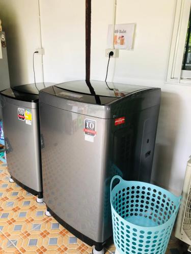 two large computer monitors sitting next to a basket at Banthai Guesthouse in Phetchaburi