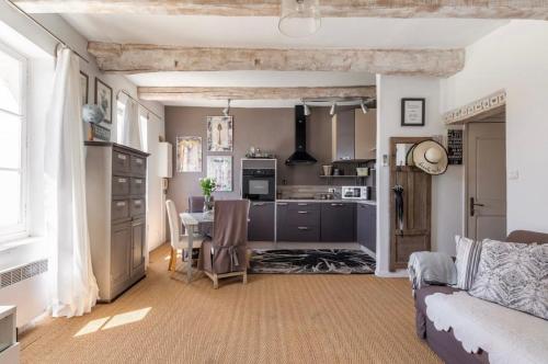 une cuisine et un salon avec un canapé et une table dans l'établissement Douceur sur la Sorgue, à LʼIsle-sur-la-Sorgue