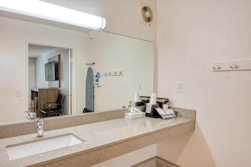 a bathroom with a sink and a large mirror at Vagabond Inn San Luis Obispo in San Luis Obispo