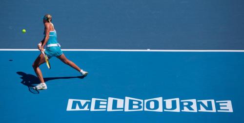 a woman hitting a tennis ball on a tennis court at St Kilda Style - Stunning 3 Bedroom House in Melbourne