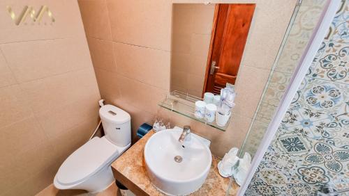 a bathroom with a toilet and a sink and a shower at VNAHOMES Serviced Apartment in Hanoi