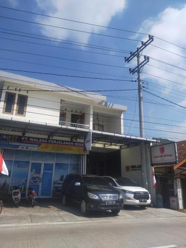 a car parked in front of a car dealership at Walasa Ayu Homes By MSH in Piyono