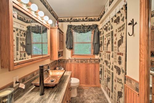 a bathroom with a sink and a toilet at Spacious Frazee Home with Direct Lake Access! in Frazee
