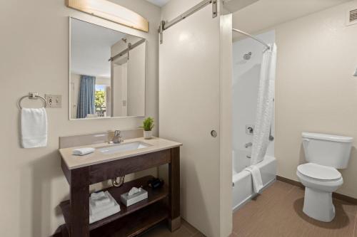 a bathroom with a sink and a toilet and a shower at Good Nite Inn Buena Park in Buena Park