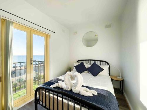 a bedroom with a bed with a towel animal on it at beachfront apartment 5/22 Esplanades seaviews in Glenelg