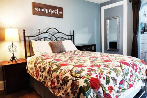 a bedroom with a bed with a colorful comforter at Private Studio- Queen Bed- 10 min to DT Indy in Indianapolis