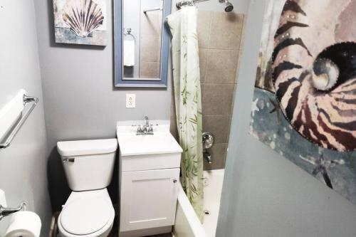 a bathroom with a toilet and a sink and a shower at Private Studio- Queen Bed- 10 min to DT Indy in Indianapolis