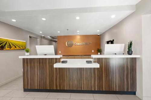 an office lobby with two desks with laptops on them at Good Nite Inn Camarillo in Camarillo