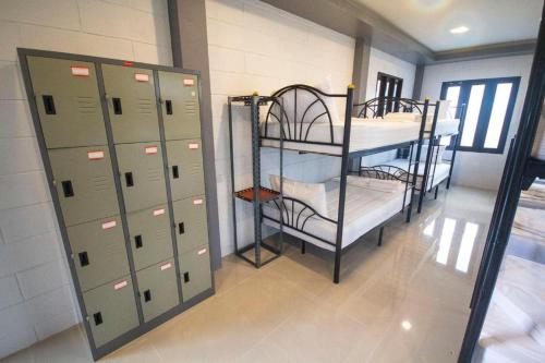 a locker room with two bunk beds and lockers at Billabong Hostel in Baan Tai