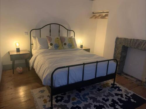 a bedroom with a bed and a fire place at Aberaeron Island House - Panoramic Harbour Views in Aberaeron