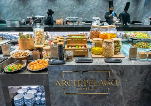 a buffet of food on a table in a kitchen at Sama Sama Hotel KLIA in Sepang