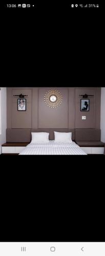 a bedroom with a large white bed with a mirror at Hotel The Quin in Hai Phong