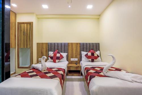 two beds in a room with swans on them at BKC Corporate Hostel Ac Dormitory in Mumbai