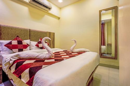 two swans on a bed in a room at BKC Corporate Hostel Ac Dormitory in Mumbai