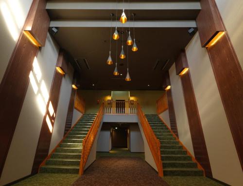 a hallway of a building with stairs and lights at Hakodate Onuma Tsuruga Resort EPUY- 30km from Hakodate Station in Hakodate