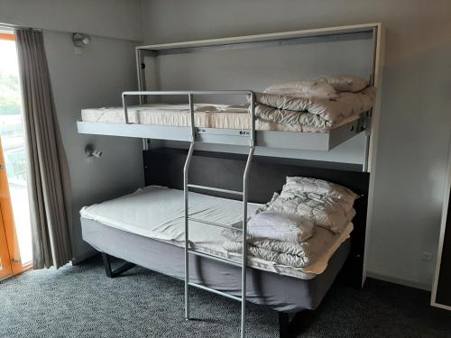 En eller flere senge i et værelse på Kolding Sportel