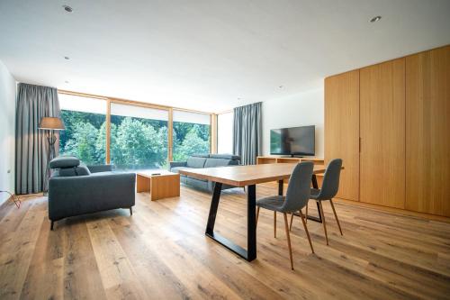 a living room with a wooden table and chairs at Greva Apartments 1 in Santa Cristina in Val Gardena