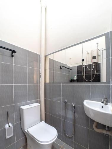 a bathroom with a toilet and a sink at HILMERA Guesthouse in Kuantan
