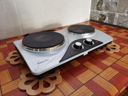 a stove with two burners sitting on the floor at Pesona Suri Homestay in Batu Pahat