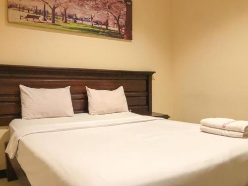 Ένα ή περισσότερα κρεβάτια σε δωμάτιο στο Hotel D'Mario Palopo