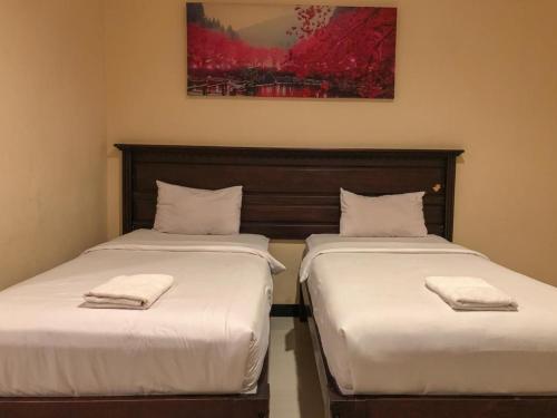 Ένα ή περισσότερα κρεβάτια σε δωμάτιο στο Hotel D'Mario Palopo