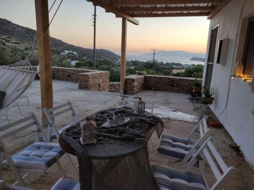 a table and chairs on a patio with a view at Villa Elia Ios in Ios Chora