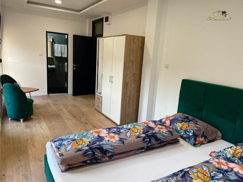a bedroom with a bed and a cabinet in it at Motel Platani Kotor Varoš in Kotorište