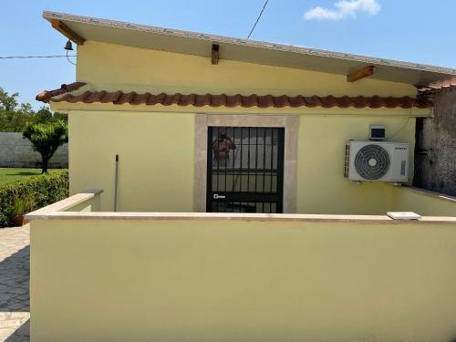 a small house with a gate and a microwave at B&b brunos&brunos in Anzio