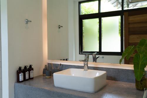 a white sink in a bathroom with a window at THALEMAAN POOL VILLA in Koh Samui 
