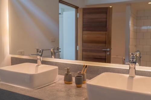 a bathroom with two sinks and a large mirror at THALEMAAN POOL VILLA in Koh Samui 