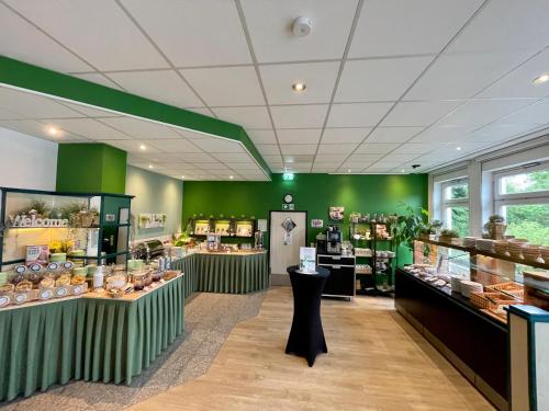 a store with green walls and counters in a store at ACHAT Hotel Monheim am Rhein in Monheim