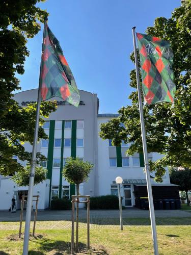 two flags in front of a building at ACHAT Hotel Monheim am Rhein in Monheim