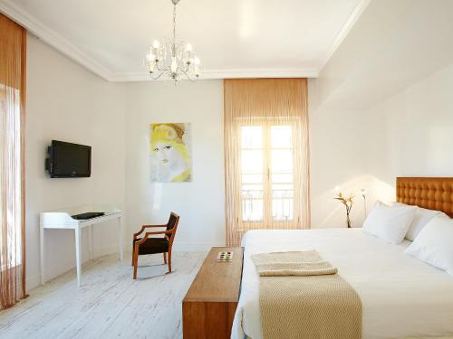 A bed or beds in a room at Grecotel Pallas Athena