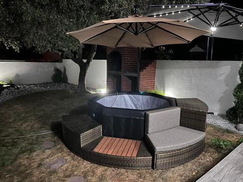 a chair and an umbrella in a yard at Villa Mungo in Starigrad-Paklenica