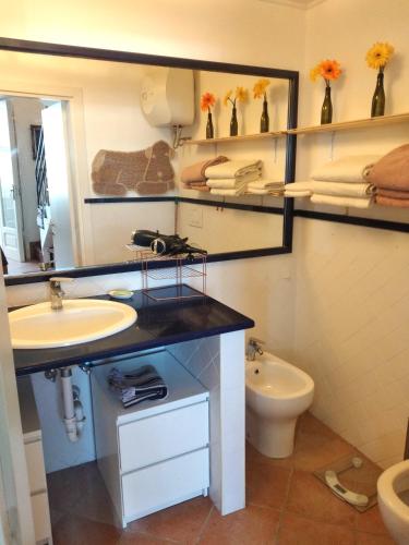 a bathroom with a sink and a toilet at Casa di Grazia in Forio d'Ischia