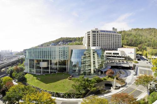 a large building with a park in front of it at Swiss Grand Hotel Seoul & Grand Suite in Seoul