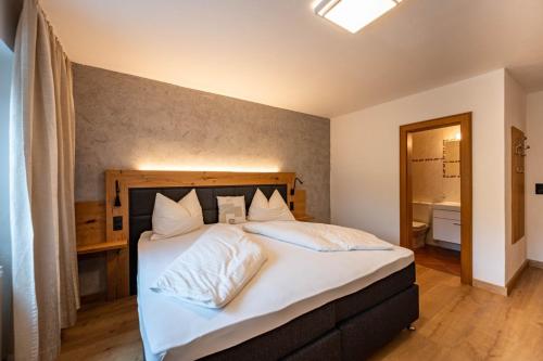 a bedroom with a large bed with white pillows at Beim Franz in Lermoos