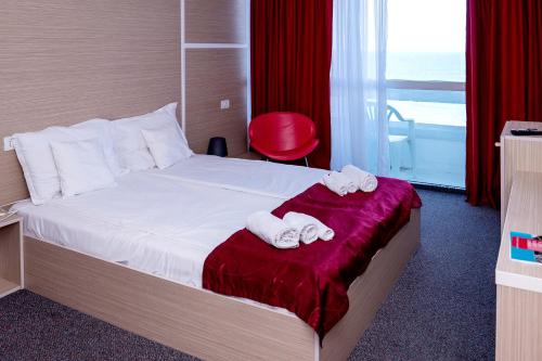 a hotel room with a bed with towels on it at Hotel Opal in Jupiter