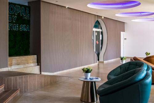 a lobby with a blue chair and a table at Hotel Opal in Jupiter