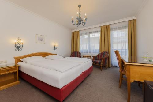 Ein Bett oder Betten in einem Zimmer der Unterkunft Hotel Tauernhof