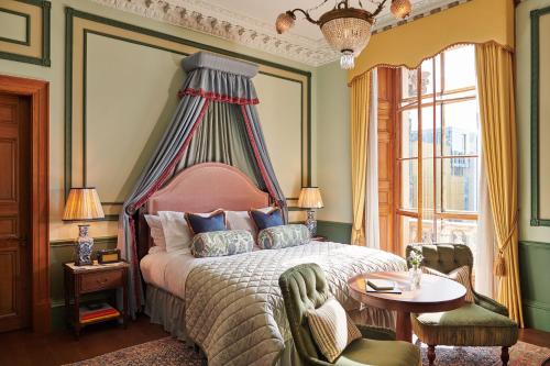 a bedroom with a bed with a canopy at Gleneagles Townhouse in Edinburgh