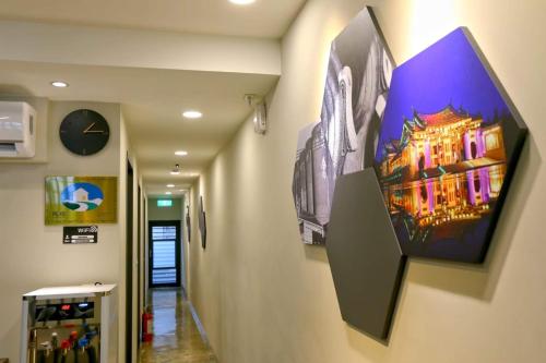 a hallway with a painting on the wall at Lukang Barn Inn in Lugang