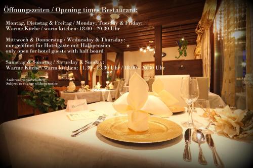 a table with a white table cloth with a plate on it at Bernerhof Swiss Quality Hotel in Kandersteg