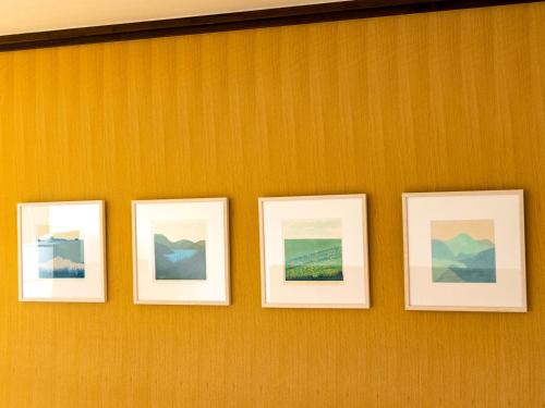 four pictures hanging on a wall at kamosu mori in Tokamachi